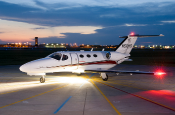 An airplane in on the ground with exterior lights on at night representing of Ameen exterior LED light project
